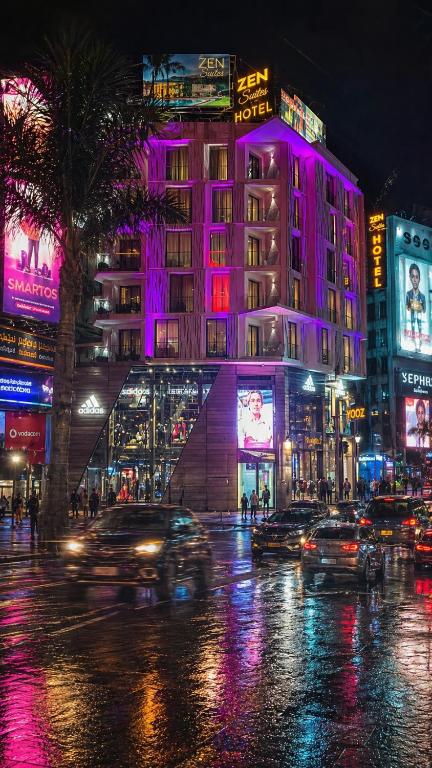 a city with cars driving down a street at night at ZEN Suites Hotel Massira in Casablanca