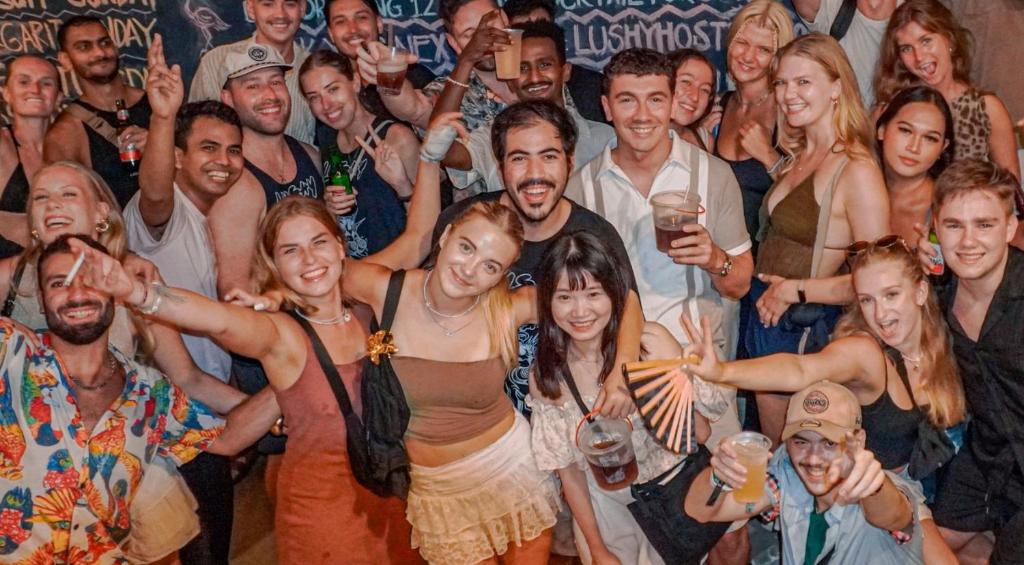 a group of people posing for a picture at a party at Lushy Hostel Kuta Legian in Legian