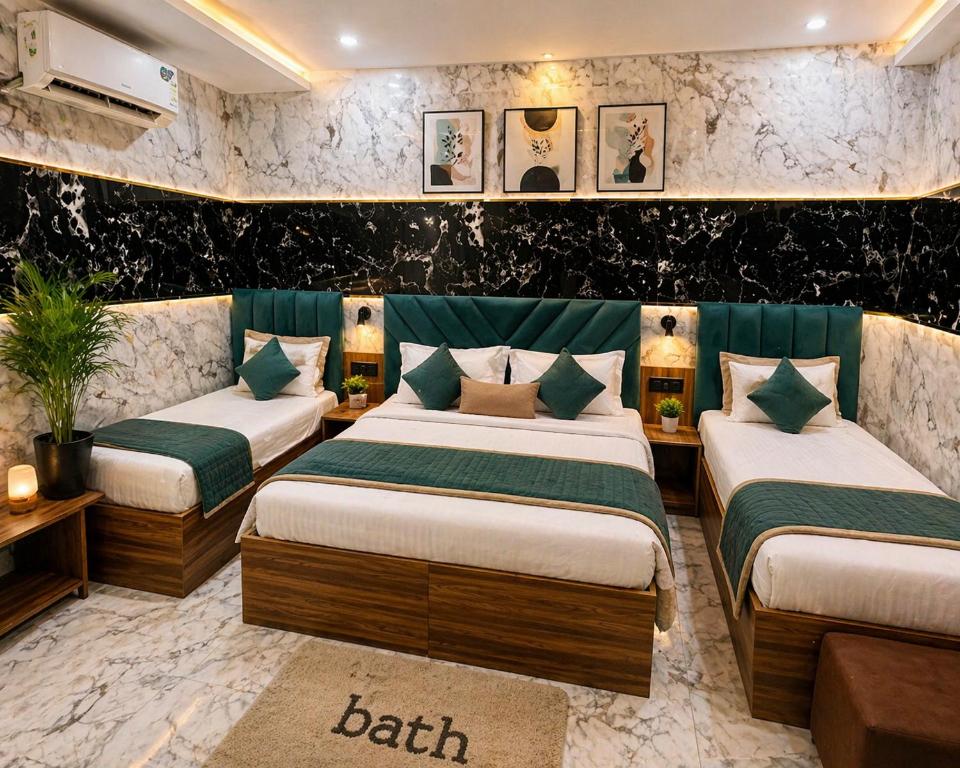 a room with three beds and a couch at Hotel Jyoti Stay Inn 2 Min to Ram Tample in Ayodhya