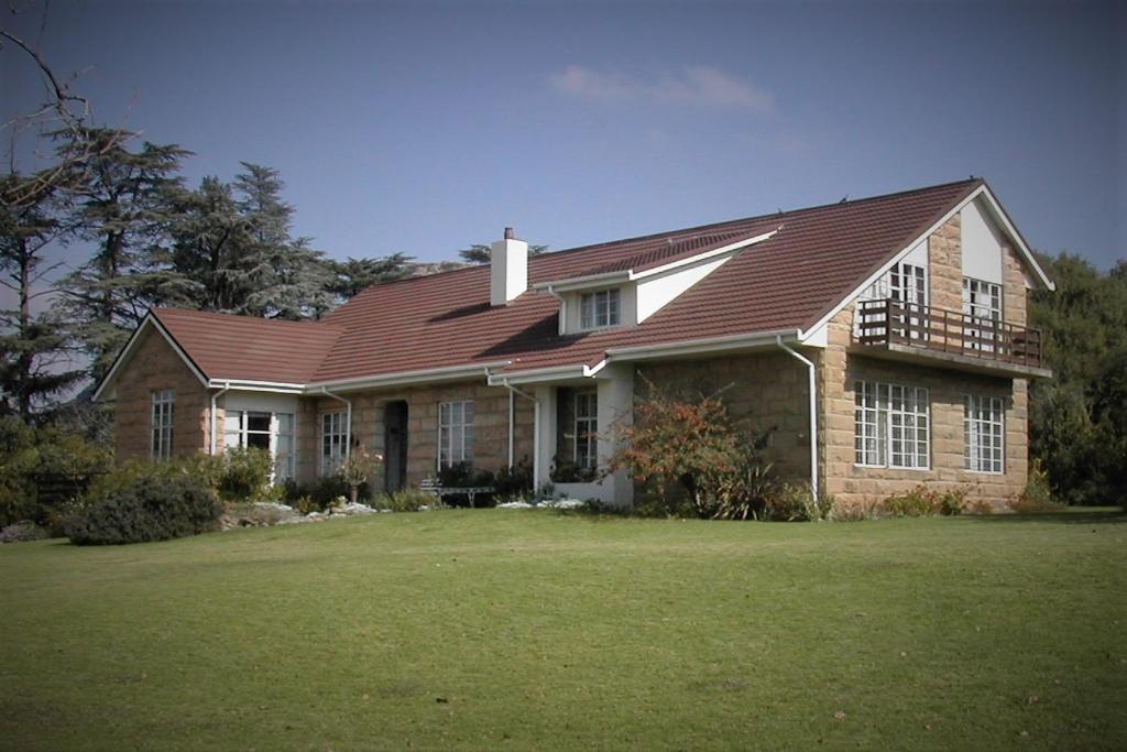 a large brick house with a brown roof at Ben Nevis Guest House in Clocolan