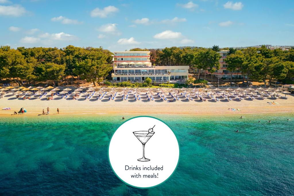 a view of a beach with a drink holder in the water at Hotel Zora in Primošten