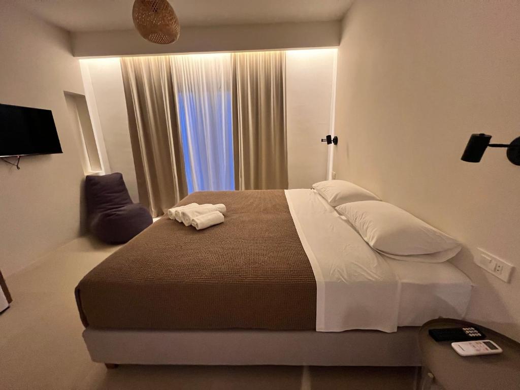 a bedroom with a large bed and a window at Villa Calliope in Himare