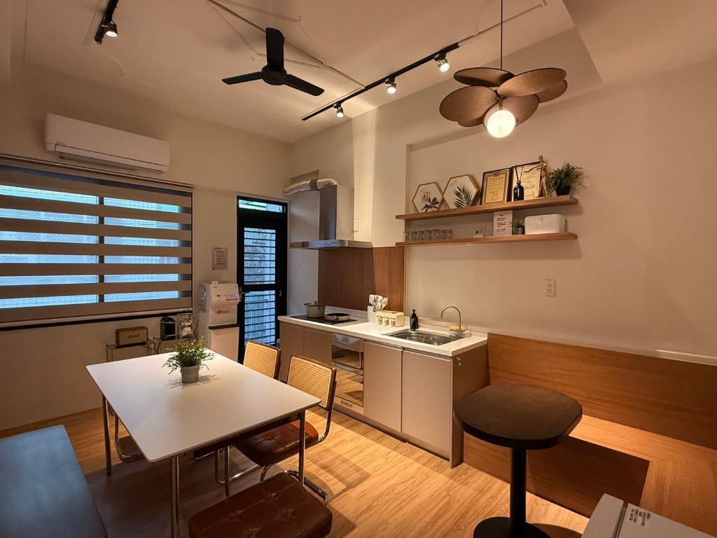a kitchen with a table and a counter top at Tainan Little Day in Tainan