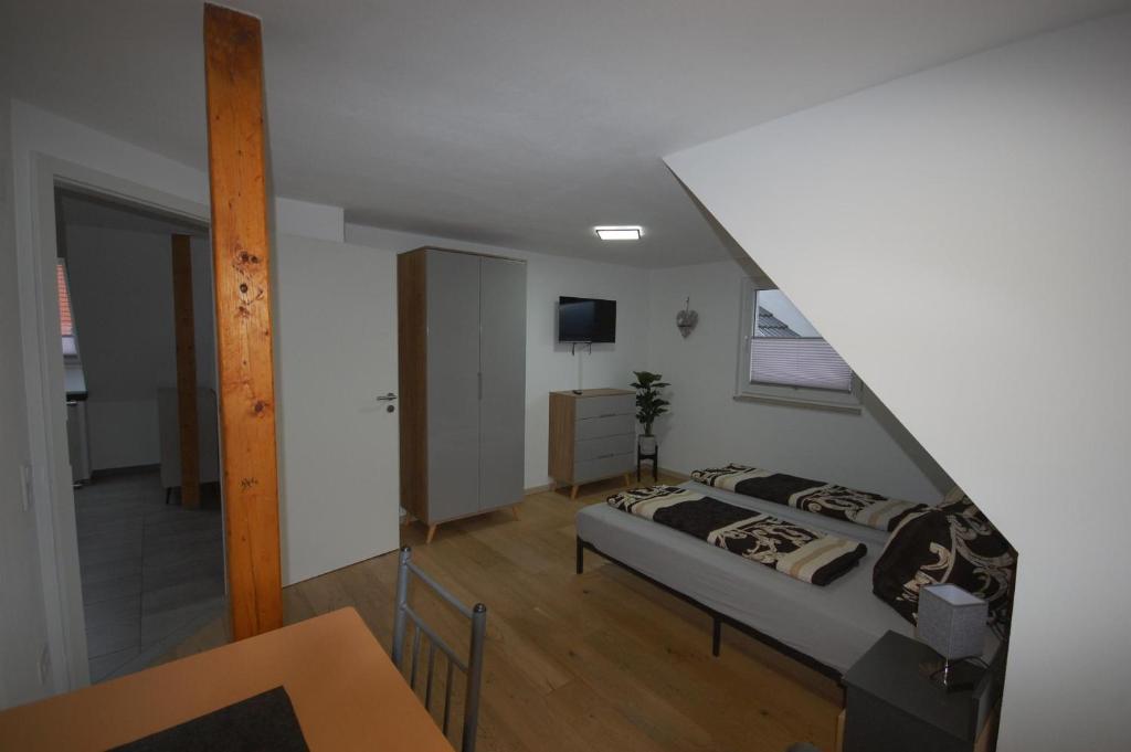 a bedroom with a bed and a staircase at Haus Schambachtal in Treuchtlingen