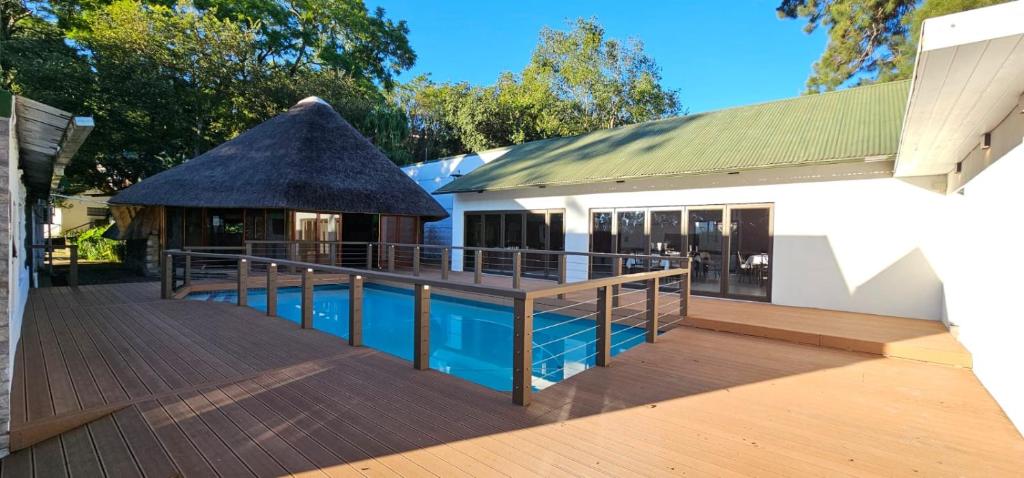 a house with a swimming pool and a gazebo at Farquhar Lodge in Ladysmith