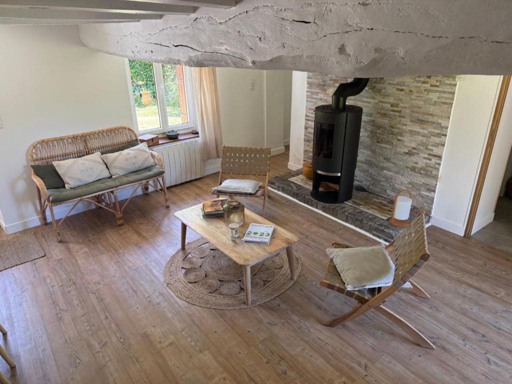 an overhead view of a living room with a fireplace at Le Clos du Avre - Maison calme & jardin verdoyant in Breux-sur-Avre