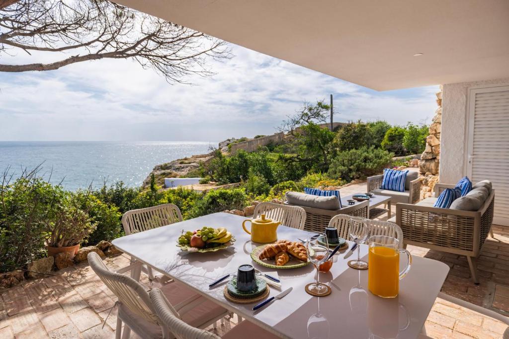 a table with a plate of food on a patio at Refugio in Carvoeiro