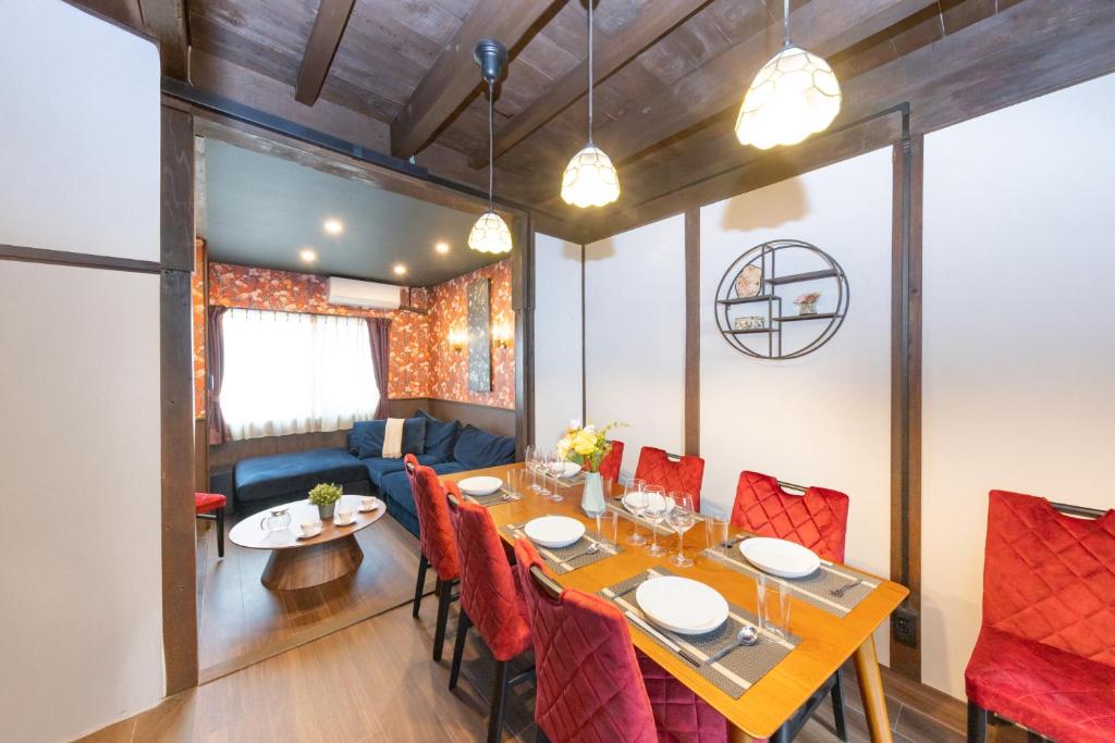 a dining room with a table and red chairs at Nagoya JADE GRACE in Nagoya