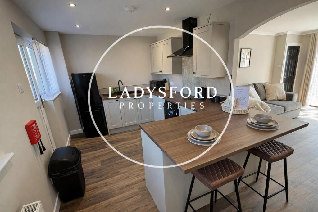 a kitchen and living room with a table and chairs at Ladysford Lets - The Duck in Peterhead