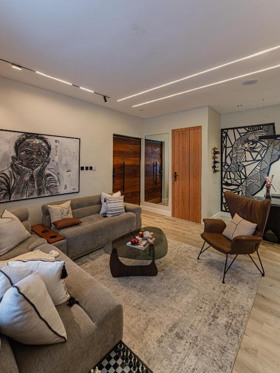 a living room with a couch and a table at M&N Apartment in Ikate