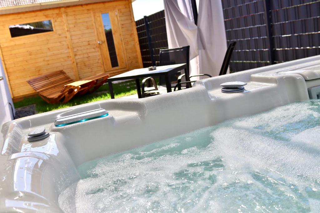 a jacuzzi tub with water in a backyard at Zuri Suite in Rittersdorf