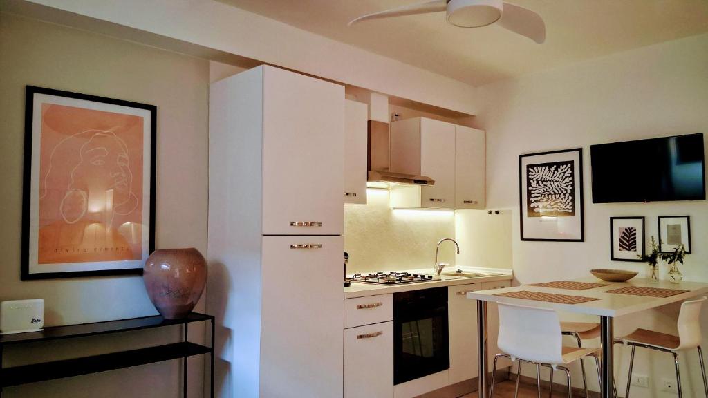a kitchen with a white refrigerator and a table at Casa Bruna in Levanto