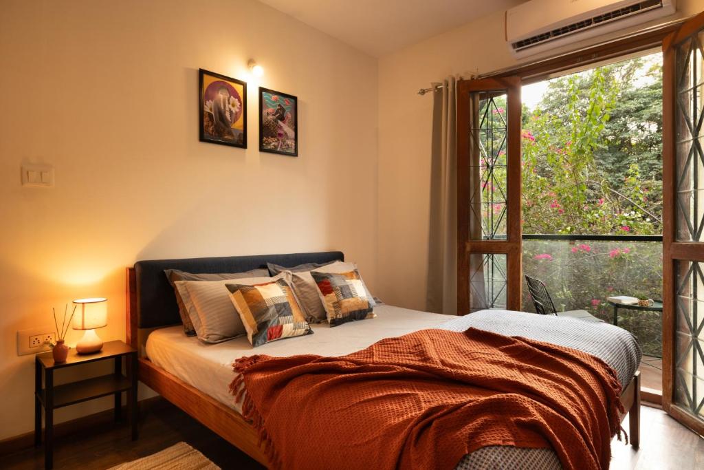 a bedroom with a bed and a large window at LiveAway Bengaluru, HSR by PACK in Bangalore