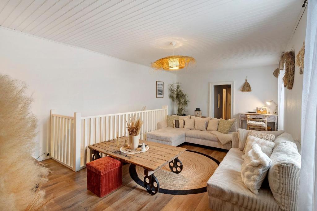 a living room with a couch and a table at Le Cocon d'Eymet village in Eymet