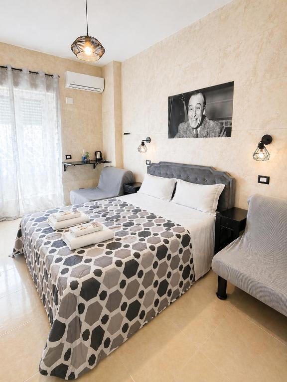 a bedroom with a large bed and two chairs at Appio Rooms Haven in Rome