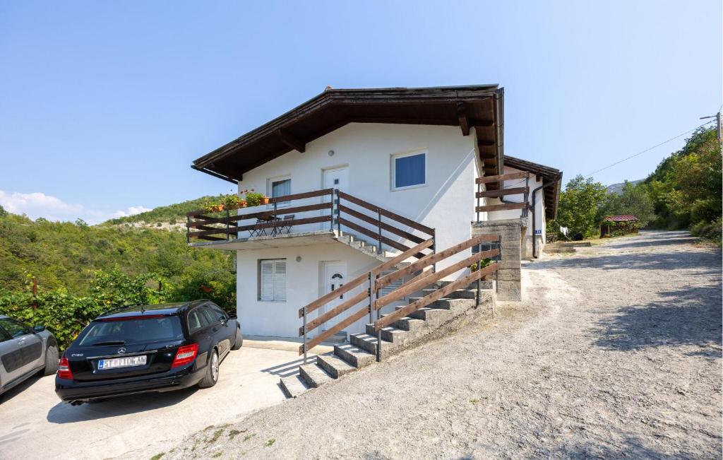a house with a car parked in front of it at Nice Apartment In Slime With Wifi in Slime