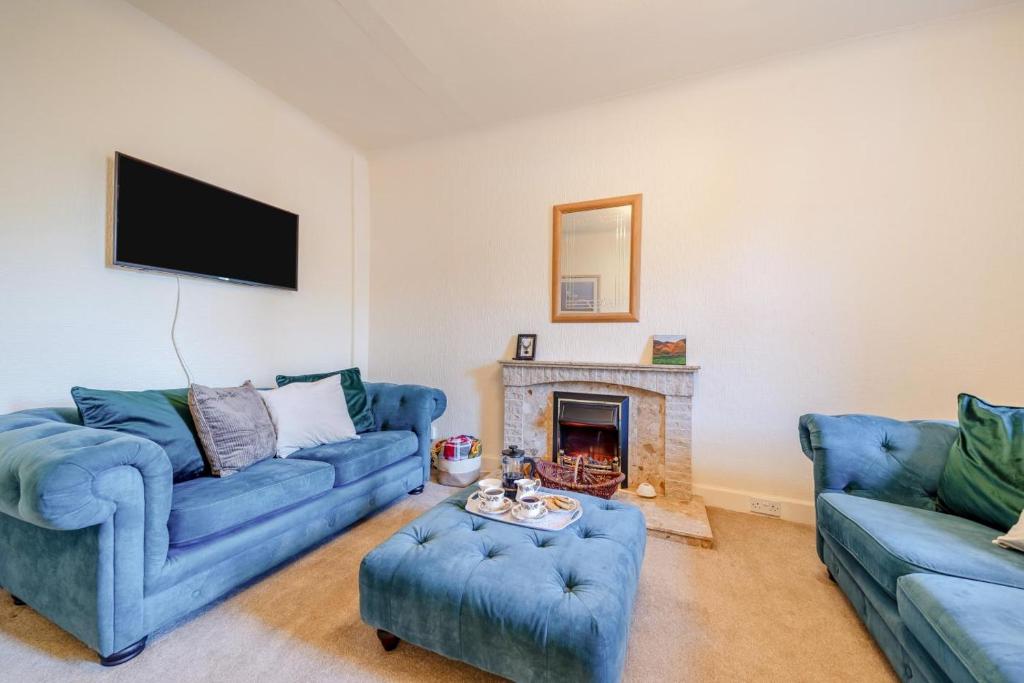 a living room with two blue couches and a fireplace at 2 Bed in Dalrymple oc-b40270 in Dalrymple