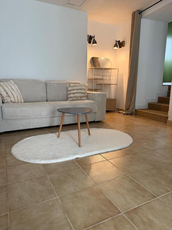 a living room with a couch and a table at Independent studio on a property in Cognac