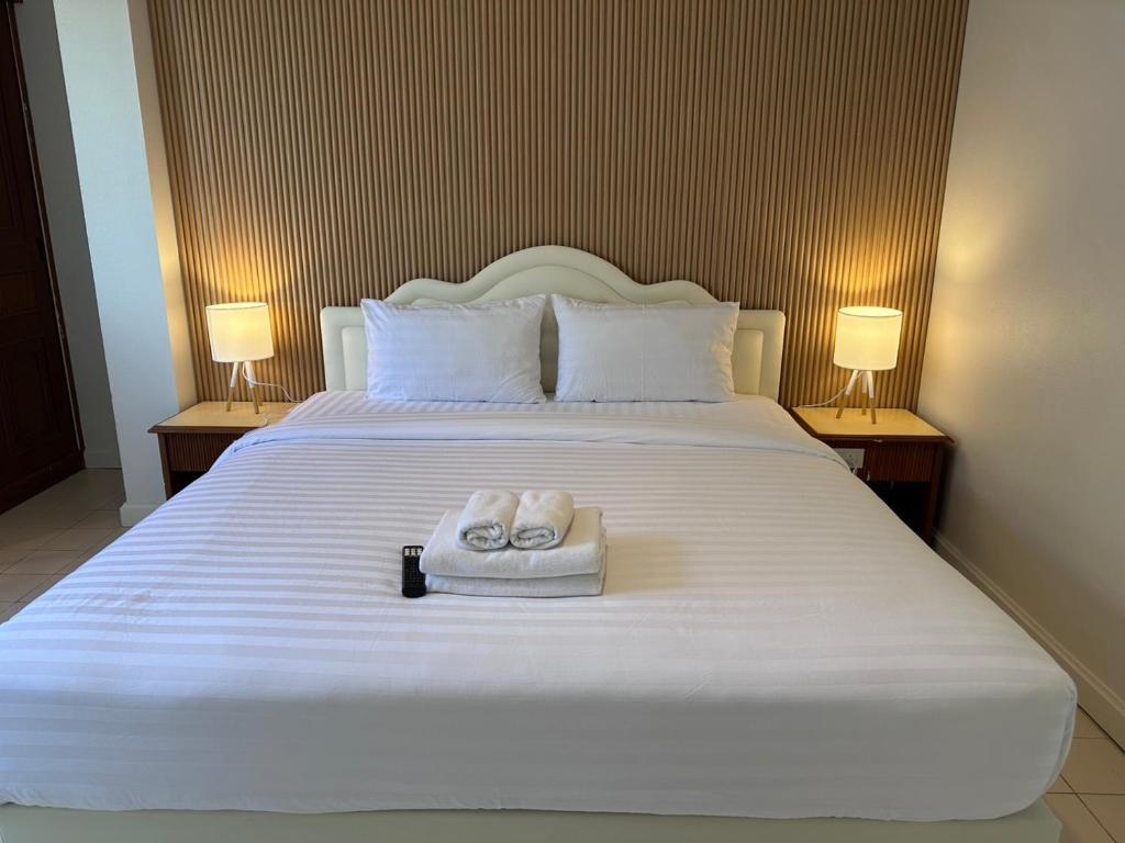 a bedroom with a bed with two towels on it at Baan Smile in Patong Beach