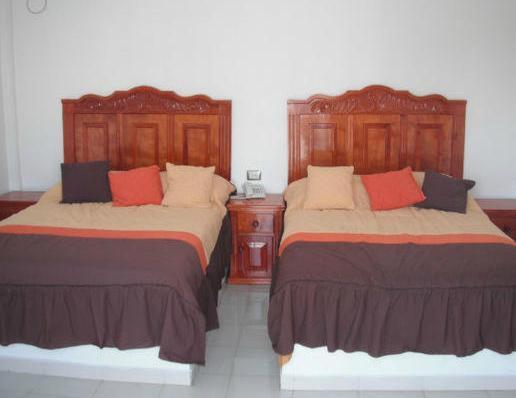 Postel nebo postele na pokoji v ubytování Hotel El Faro