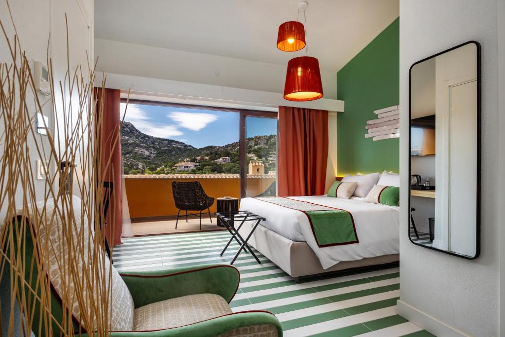 a hotel room with a bed and a balcony at Valesmeralda Boutique Rooms, Porto Cervo Marina Adults only in Porto Cervo