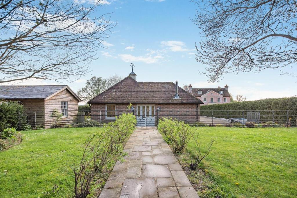 a house with a stone path in front of a yard at 2 Bed in Stoke oc-c41361 in Hurstbourne Tarrant