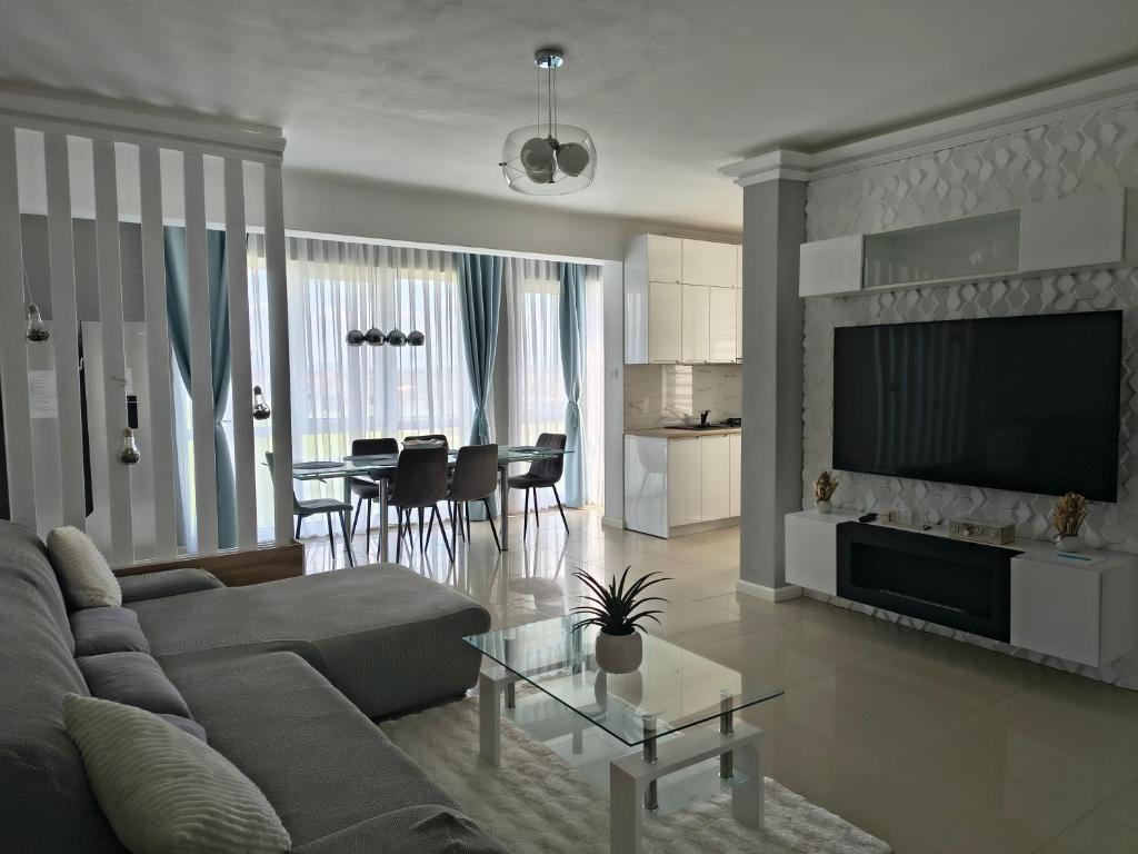 a living room with a couch and a table at Sunny Apartment in Oradea