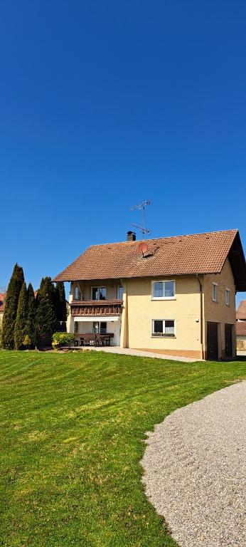 a house with a grassy field in front of it at Gästehaus Kienle in Rot an der Rot