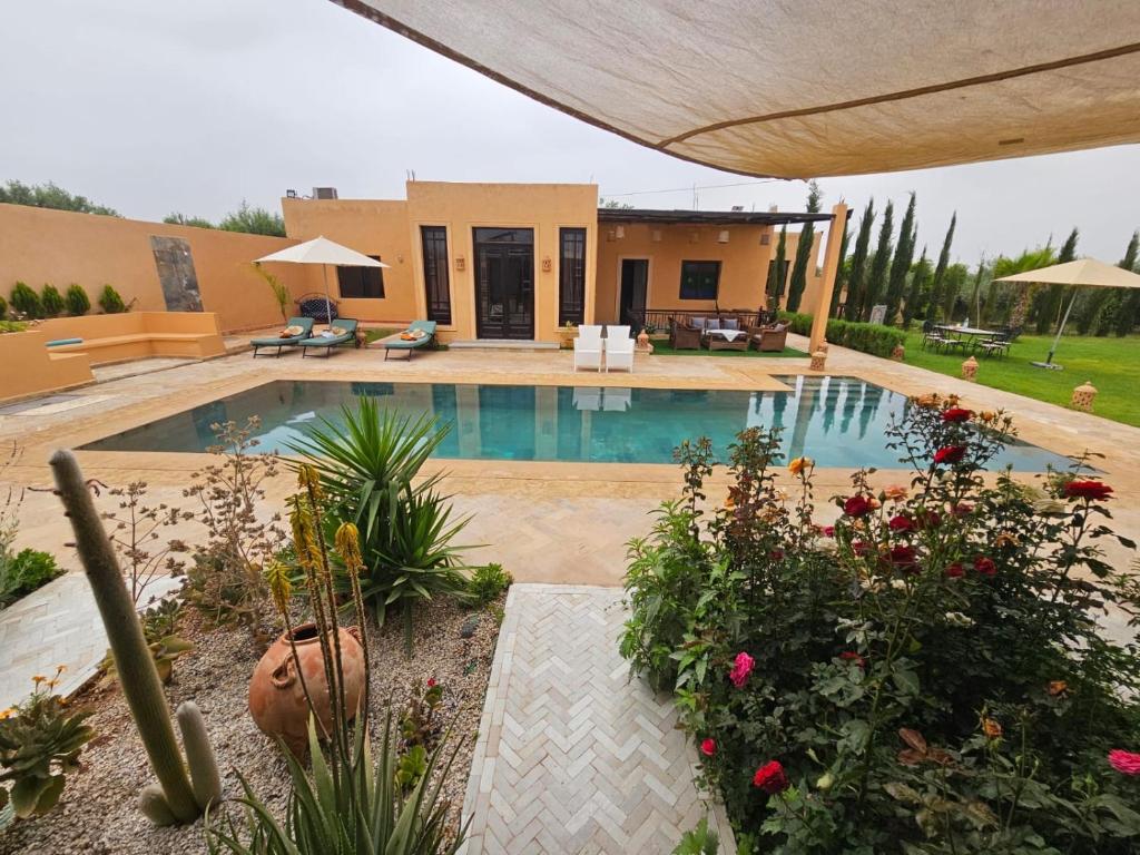 a house with a swimming pool in a yard at bled ghazal in Marrakesh