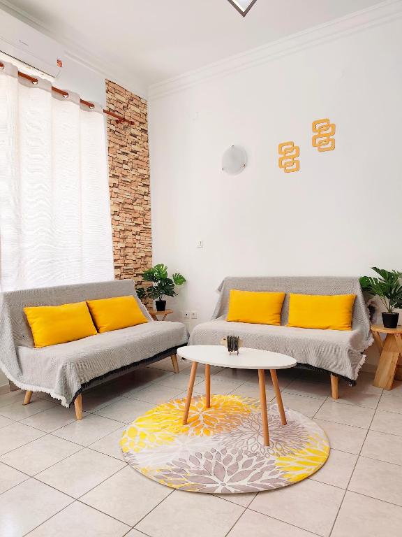 a living room with two couches and a table at Twins home in Ierapetra