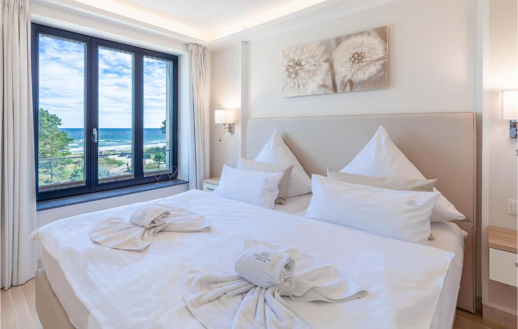 a bedroom with a white bed with towels on it at Prince in Binz
