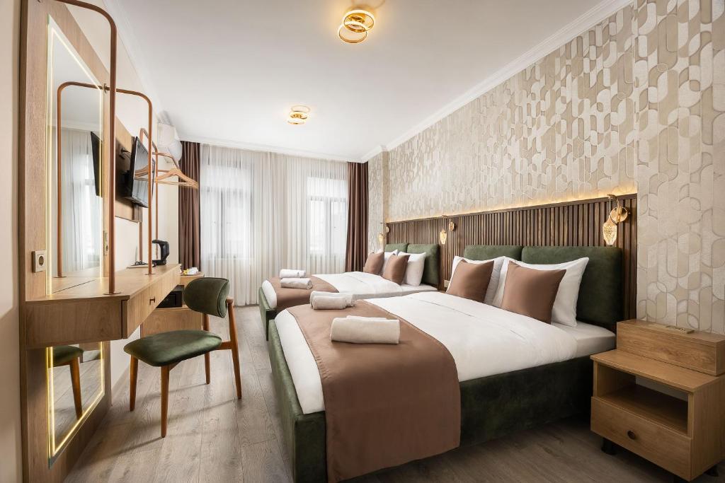 a hotel room with a large bed and a desk at Taksim Peradise Hotel in Istanbul