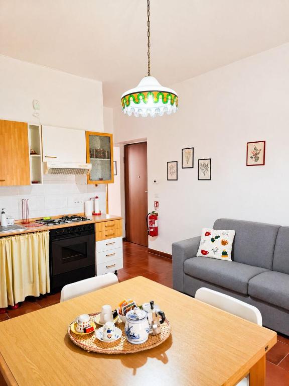 a kitchen and living room with a table and a couch at Sila Magico Incanto in Camigliatello Silano