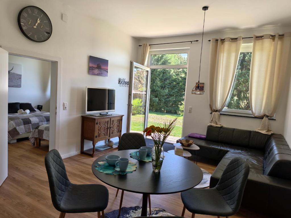 a living room with a table and a couch at Ferienwohnung Kirchenbauer in Rieding