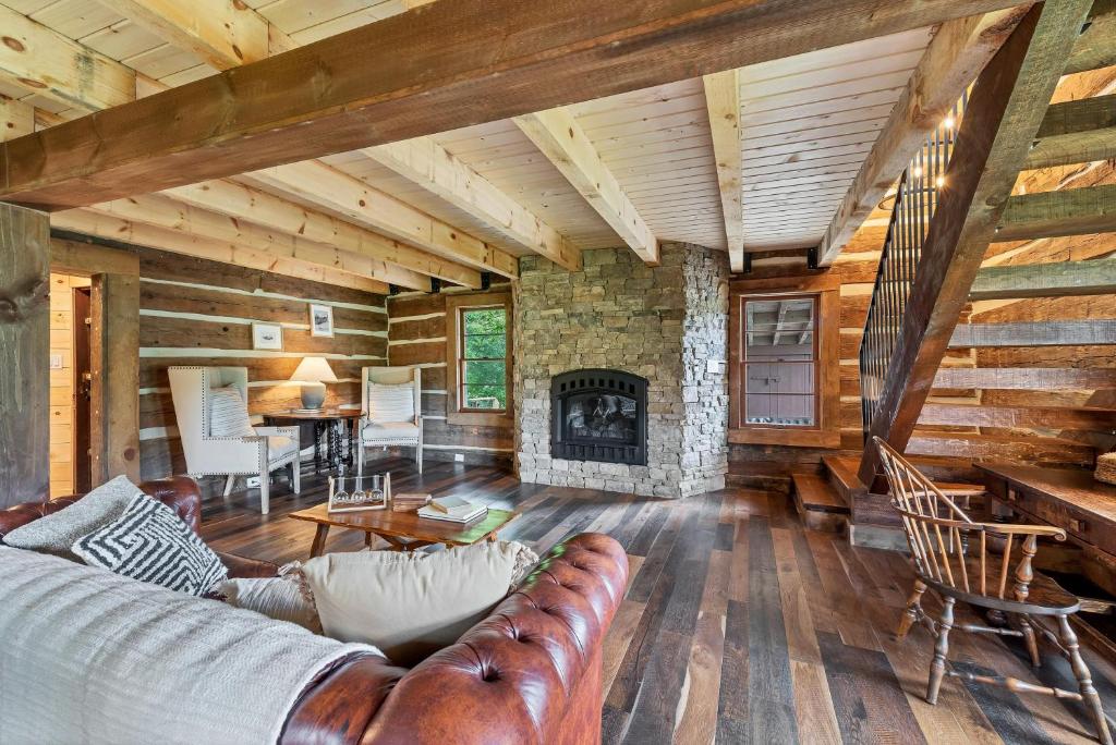 a living room with a couch and a fireplace at Riverside in Townsend
