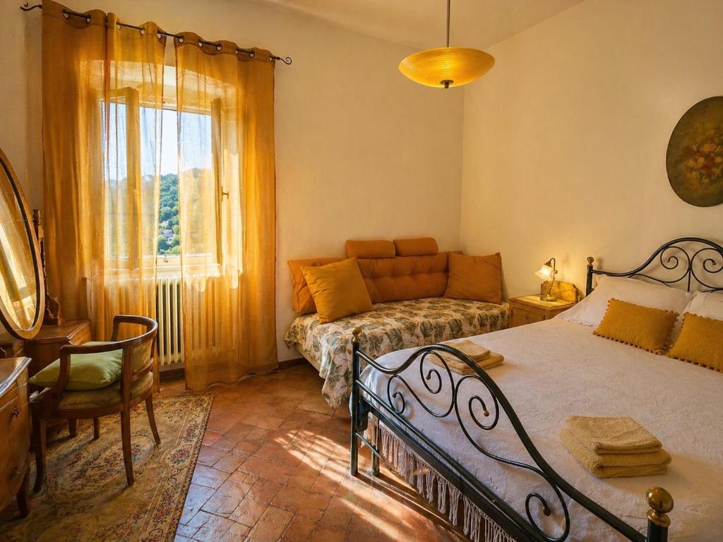 a bedroom with a bed and a couch at Casa di Nonna in Montefranco