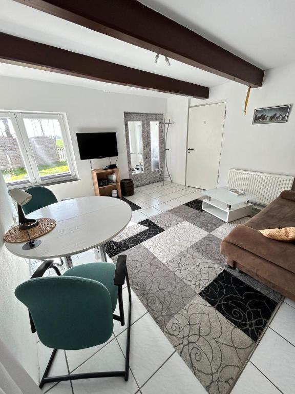 a living room with a table and a couch at Break in Kudensee