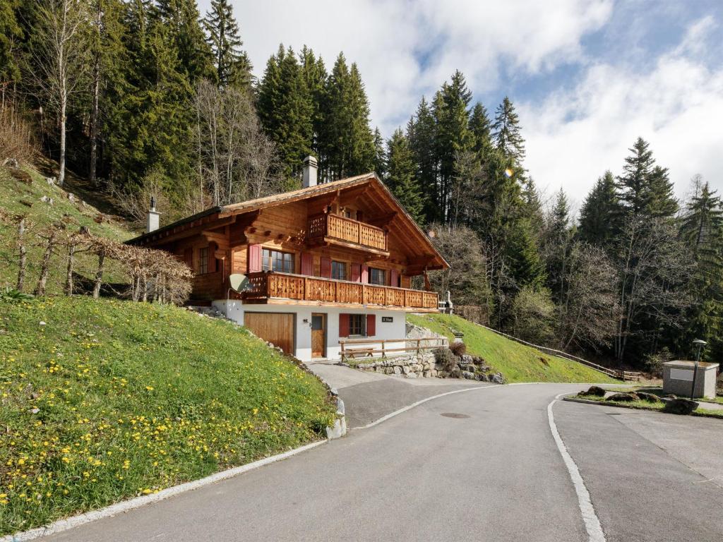 a house on a hill next to a road at Chalet Saint Piran-1 by Interhome in Villars-sur-Ollon