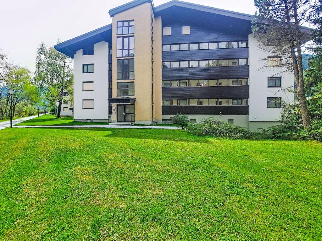 a large building with a grass field in front of it at Apartment Sepp by Interhome in Bad Hofgastein