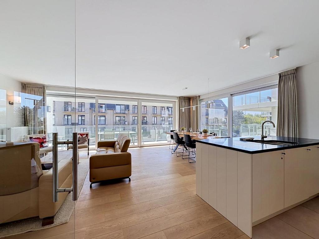 a kitchen and living room with a view of a building at Apartment Wanderlust with garage by Interhome in Mispelburg