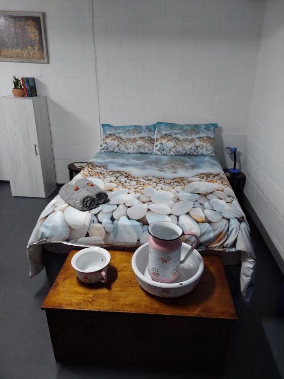 a bedroom with a bed with a table with cups and saucers at Cozy Corner Unit 1 and unit 2 in Bredasdorp