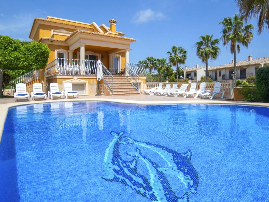 a large swimming pool in front of a house at Villa Villa Delfín by Interhome in Calpe