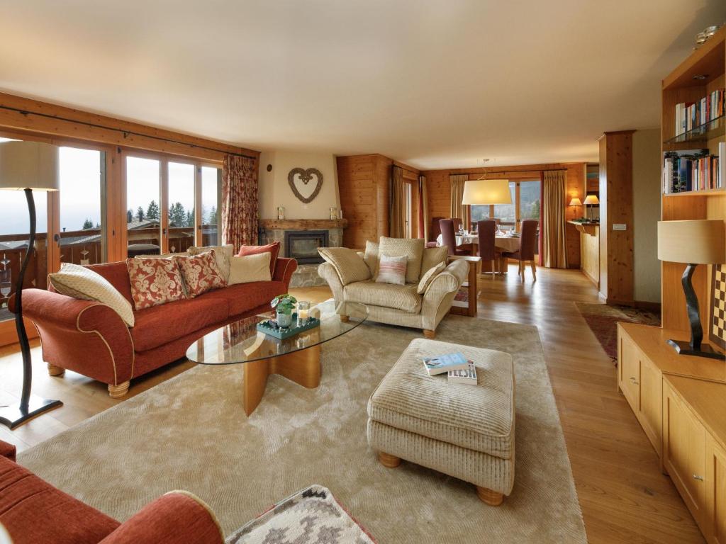 a living room with a couch and a table at Apartment Pré Vert 3 by Interhome in Villars-sur-Ollon