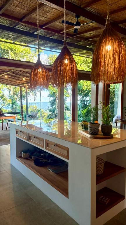 a kitchen with a counter with some lights above it at Wild Wasi - Private Jungle Villa in Puyo