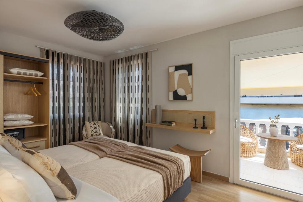 a bedroom with a bed and a view of the ocean at Annas's Main Street Apartment in Skala