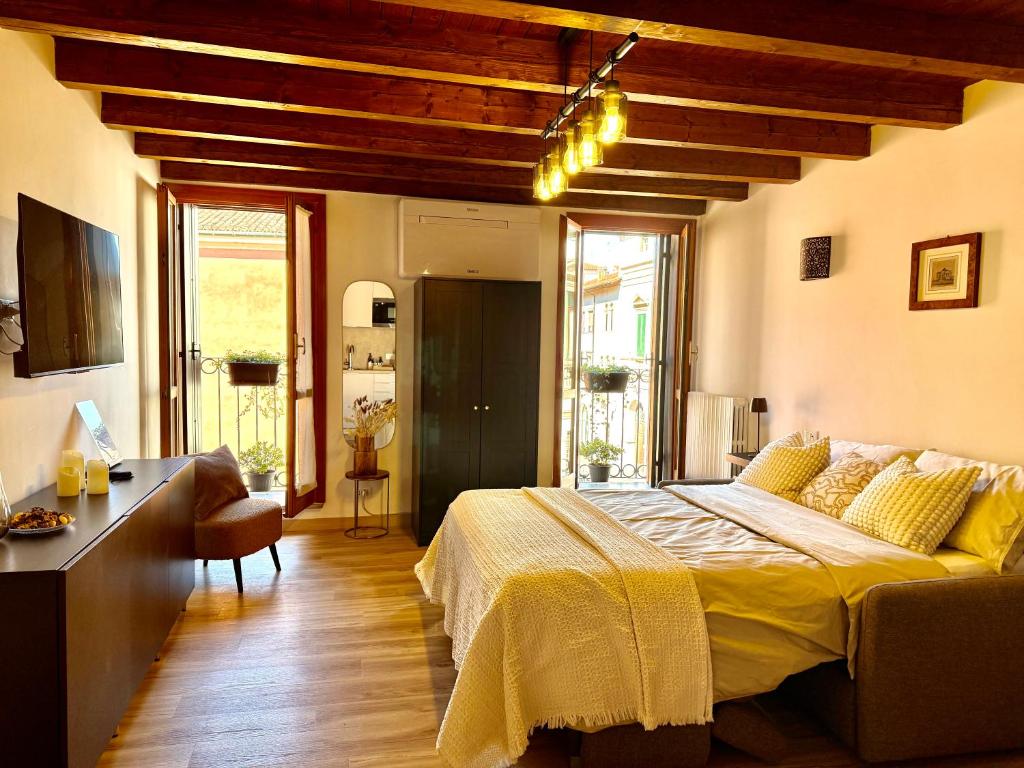 a bedroom with a large bed in a room with wooden floors at casa duomo vicenza in Vicenza