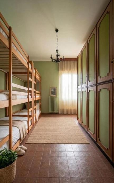 a room with bunk beds and a room with a window at Shared rooms BOC in Brunate