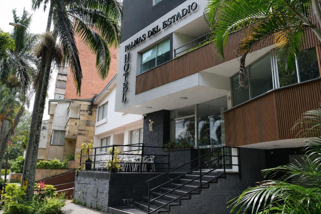 a building with a sign on the side of it at Hotel Palmas del Estadio in Medellín