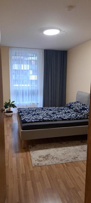a bed in a room with a window at Vita apartment in Vilnius
