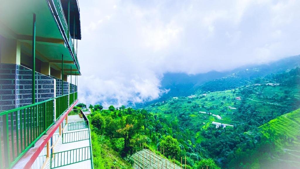 a building with a view of a mountain at pristine mountain lodge in Chail